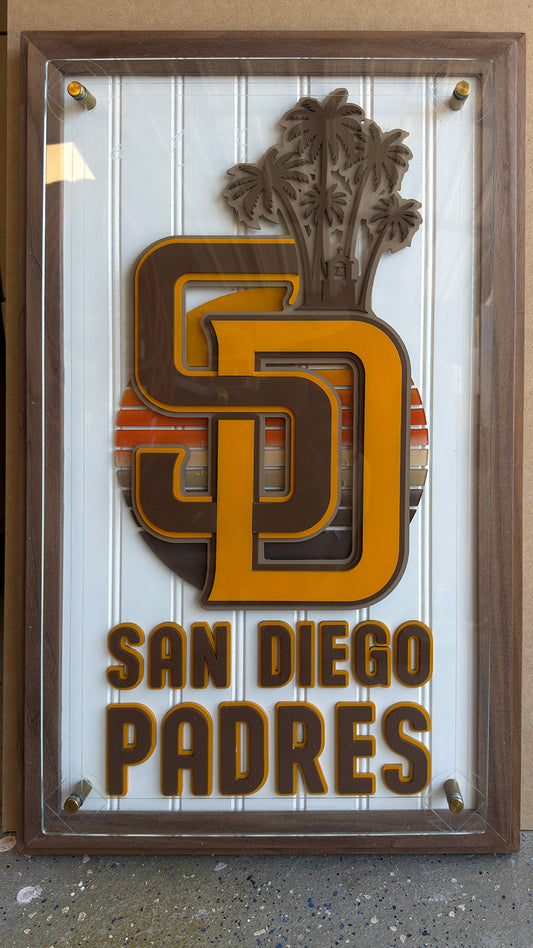 Close-up of layered San Diego baseball artwork on a custom walnut plaque