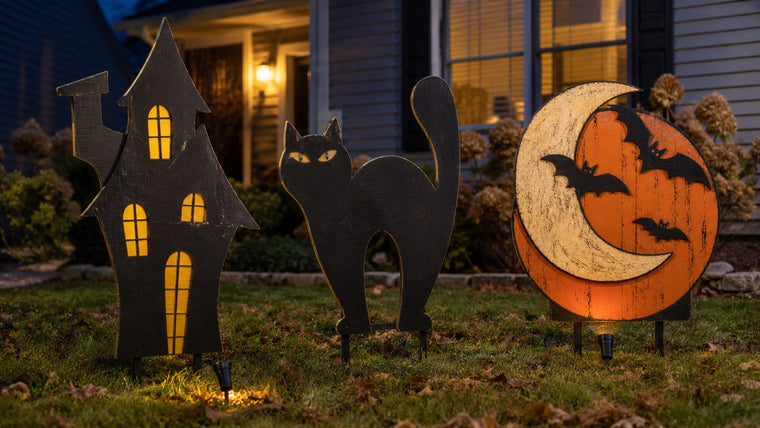 Weather-resistant painted plywood Halloween decorations installed in a front yard