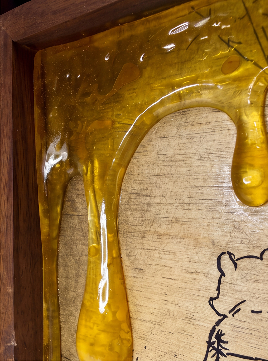 Close-up of glossy amber honey-drip details on the framed artwork