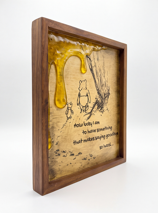 Angled view of Pooh and Piglet artwork showing the brown frame and raised honey details