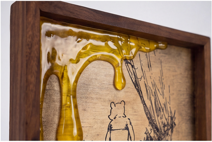 Close-up of glossy amber honey-drip details on the framed artwork